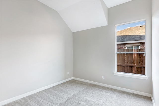 bonus room with carpet flooring and vaulted ceiling