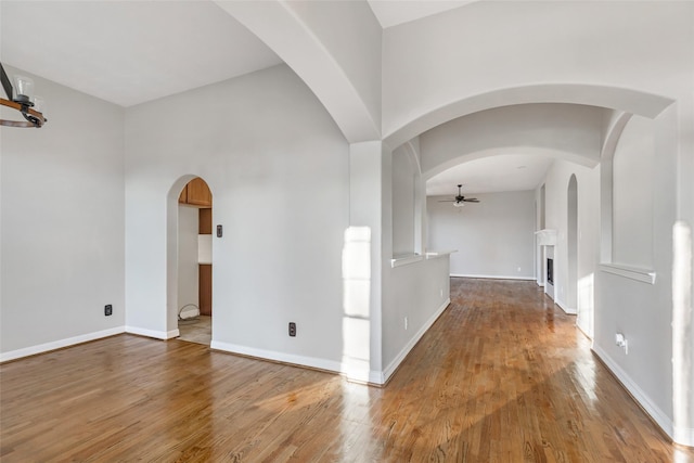 corridor with lofted ceiling and hardwood / wood-style flooring