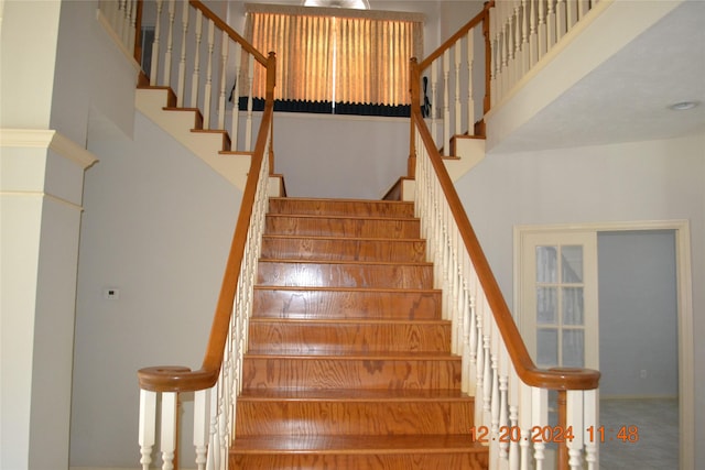 stairs featuring a high ceiling