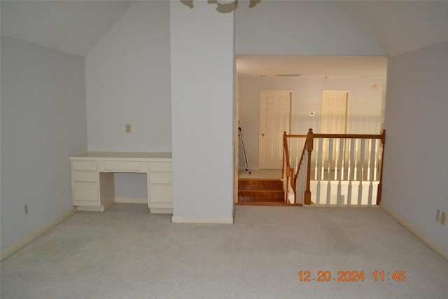 interior space with light colored carpet and lofted ceiling