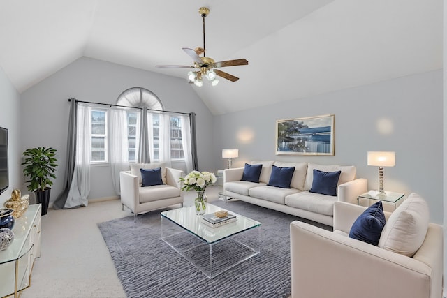 living area featuring light carpet, ceiling fan, and vaulted ceiling