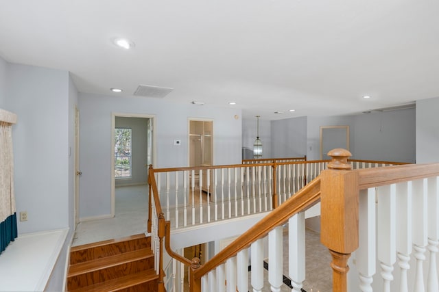 stairway with baseboards and recessed lighting