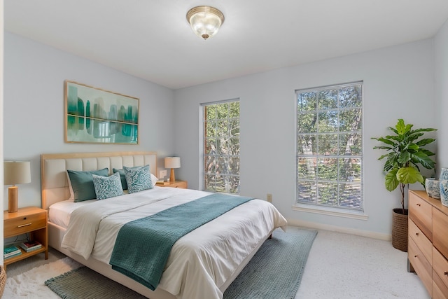 bedroom with light carpet and baseboards