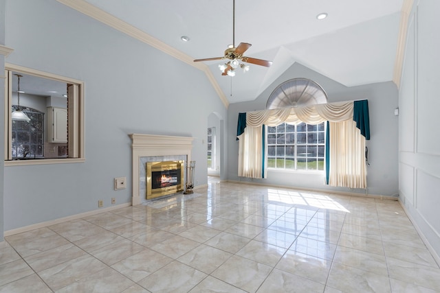 unfurnished living room featuring baseboards, a ceiling fan, ornamental molding, vaulted ceiling, and a fireplace