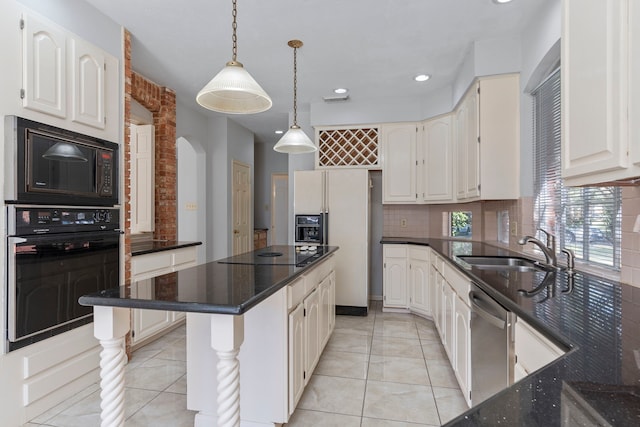 kitchen featuring white cabinetry, a sink, decorative light fixtures, and stainless steel dishwasher