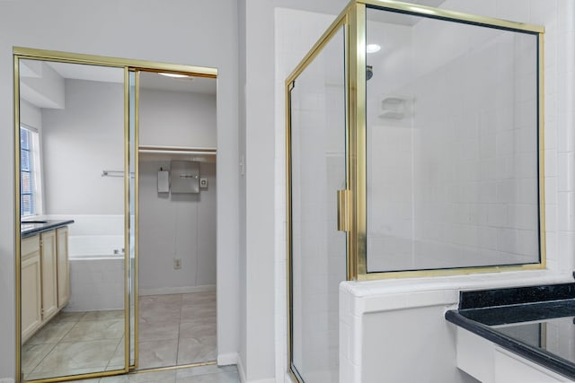 full bath featuring vanity, a stall shower, tile patterned flooring, and a bath