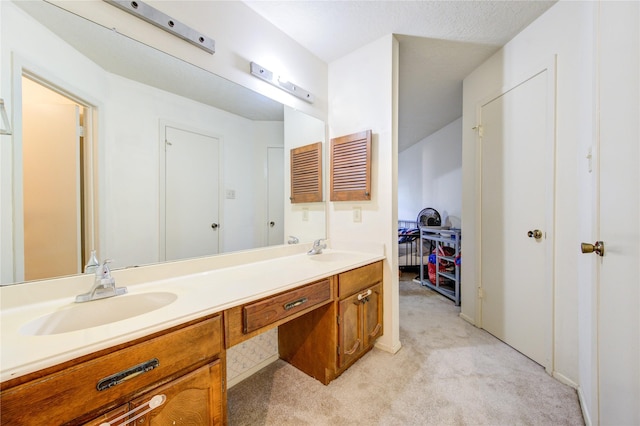 bathroom with a textured ceiling and vanity