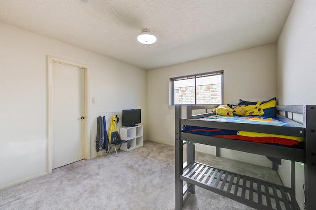 carpeted bedroom with a textured ceiling