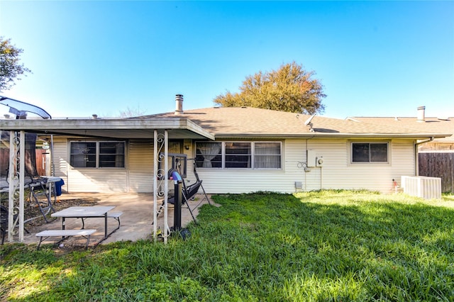 back of property featuring a yard and a patio area