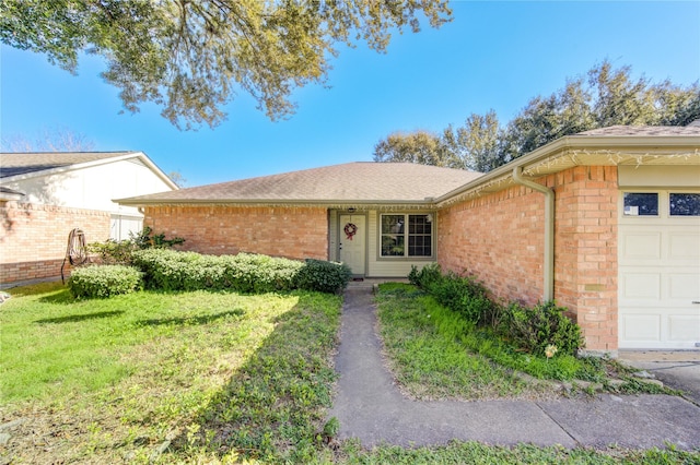 ranch-style home with a front yard and a garage