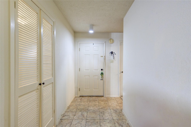 doorway featuring a textured ceiling