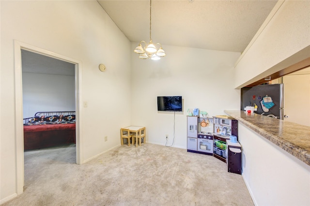 playroom featuring light colored carpet, high vaulted ceiling, and a notable chandelier