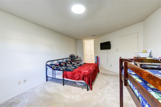 bedroom with light colored carpet