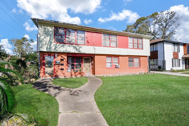 view of front of property with a front yard and cooling unit