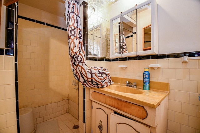 bathroom with vanity, tile walls, and a shower with shower curtain