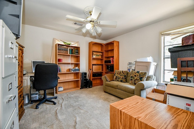 carpeted home office with ceiling fan