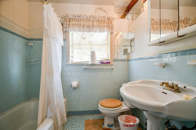 full bathroom featuring sink, shower / bath combo, tile walls, and toilet