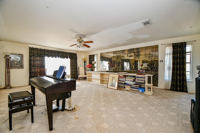 misc room with ceiling fan and light carpet