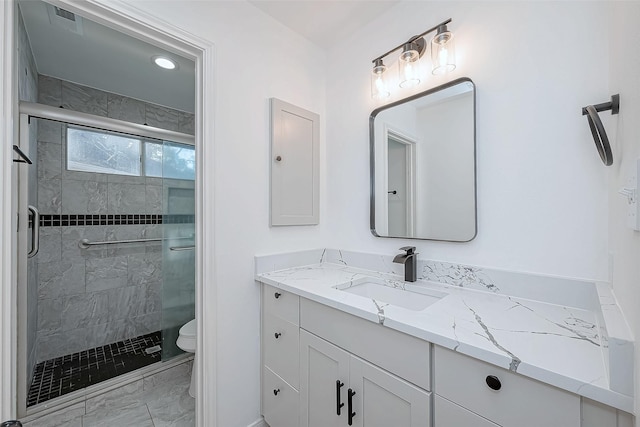 bathroom with vanity, toilet, and walk in shower