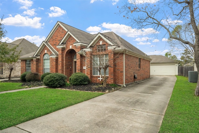 view of front of property featuring a front yard, a garage, and central air condition unit