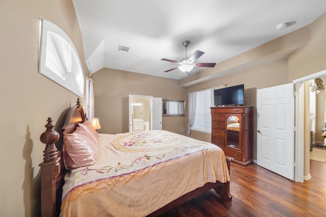 bedroom with connected bathroom, ceiling fan, dark hardwood / wood-style flooring, and multiple windows