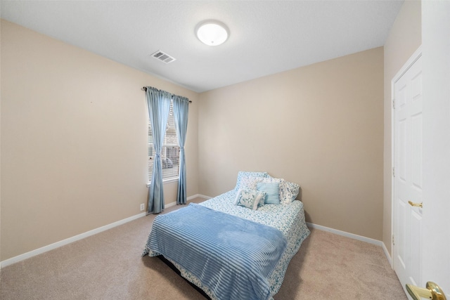 bedroom featuring light colored carpet