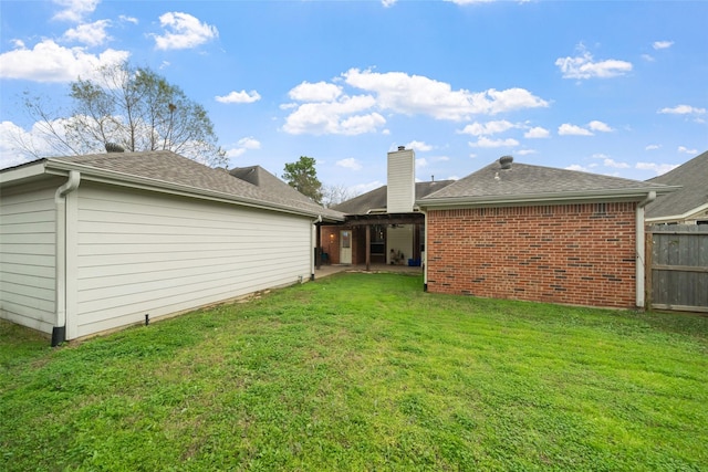 back of house with a yard