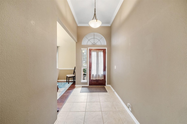 tiled foyer with ornamental molding