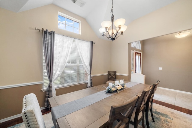 dining space with lofted ceiling and an inviting chandelier