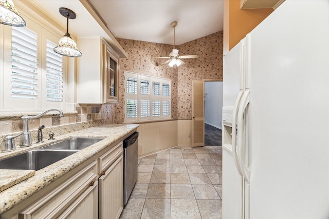 kitchen featuring lofted ceiling, white refrigerator with ice dispenser, sink, stainless steel dishwasher, and light stone counters