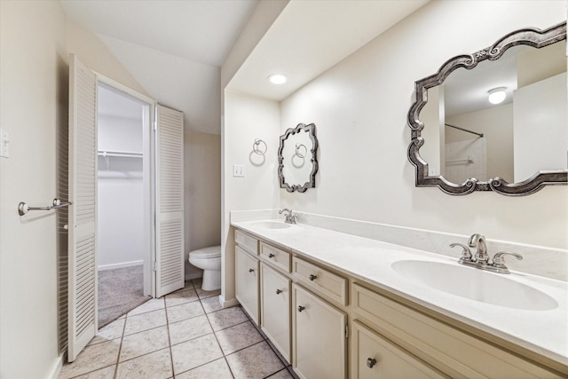 bathroom with tile patterned flooring, vanity, and toilet