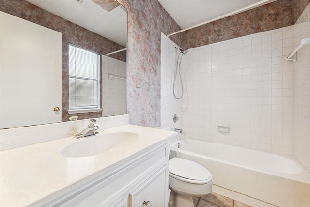 full bathroom featuring tile patterned flooring, vanity, toilet, and tiled shower / bath