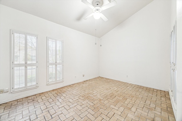 empty room featuring ceiling fan and lofted ceiling