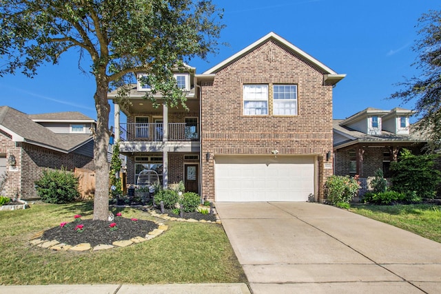 view of front property with a front yard, a balcony, and a garage