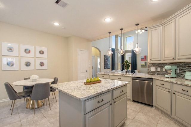 kitchen with decorative backsplash, sink, dishwasher, a center island, and hanging light fixtures