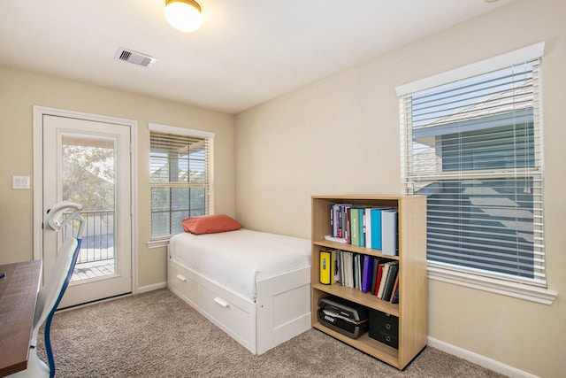 bedroom featuring access to exterior and light colored carpet