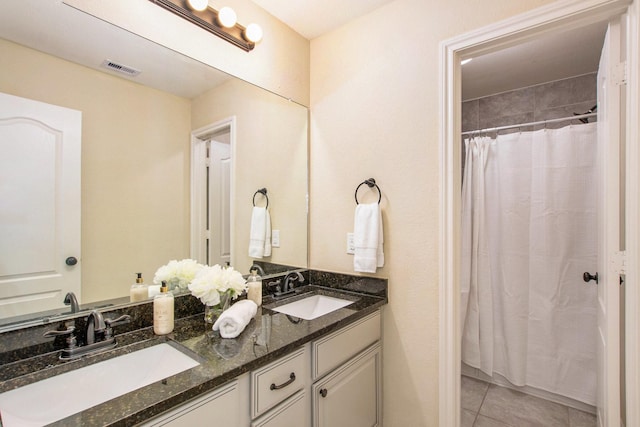 bathroom with tile patterned floors, vanity, and a shower with shower curtain