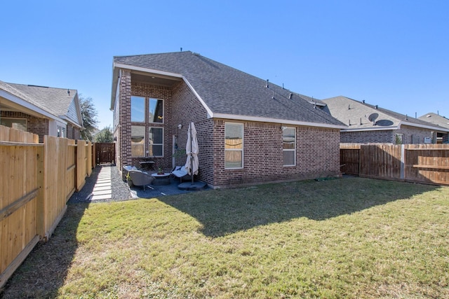 rear view of property with a patio area and a yard