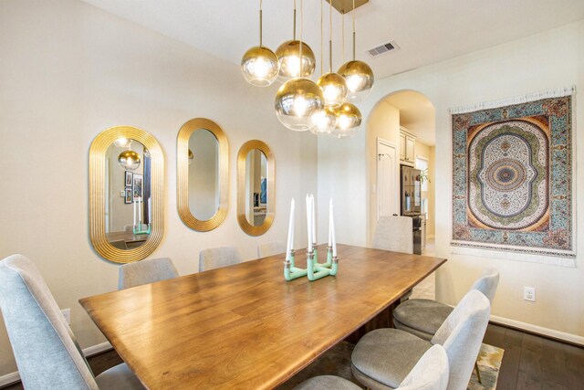 dining space with dark wood-type flooring