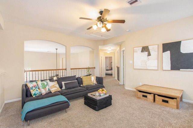 carpeted living room with ceiling fan