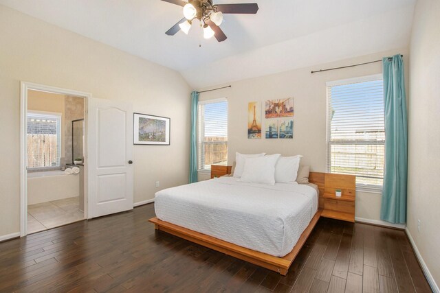 bedroom featuring ceiling fan, dark hardwood / wood-style floors, multiple windows, and vaulted ceiling