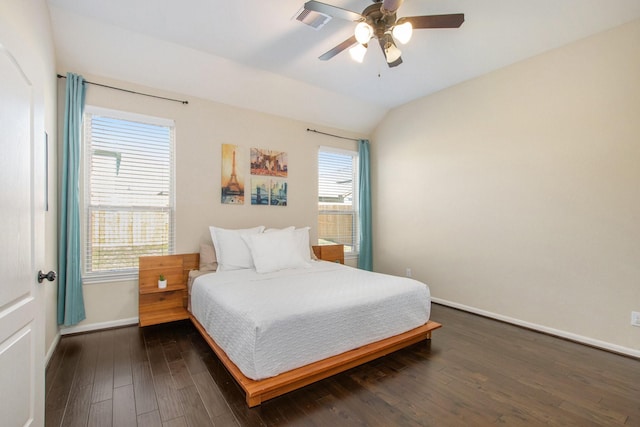 bedroom featuring multiple windows, dark hardwood / wood-style floors, ceiling fan, and lofted ceiling