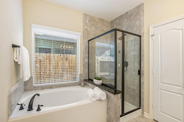 bathroom with tile patterned floors, a wealth of natural light, and independent shower and bath