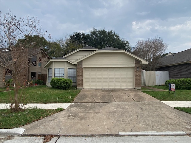 view of front of home with a front yard and a garage