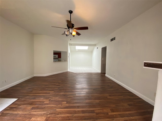 spare room featuring ceiling fan and dark wood-type flooring