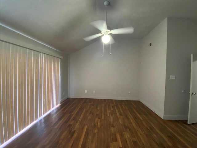 spare room with ceiling fan, dark hardwood / wood-style flooring, and vaulted ceiling