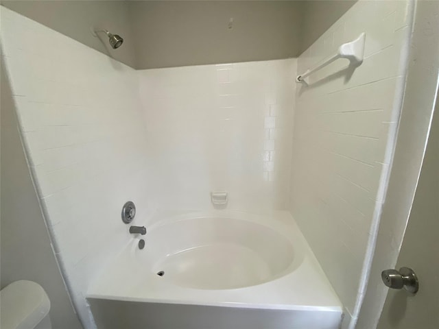 bathroom with shower / bathing tub combination and toilet