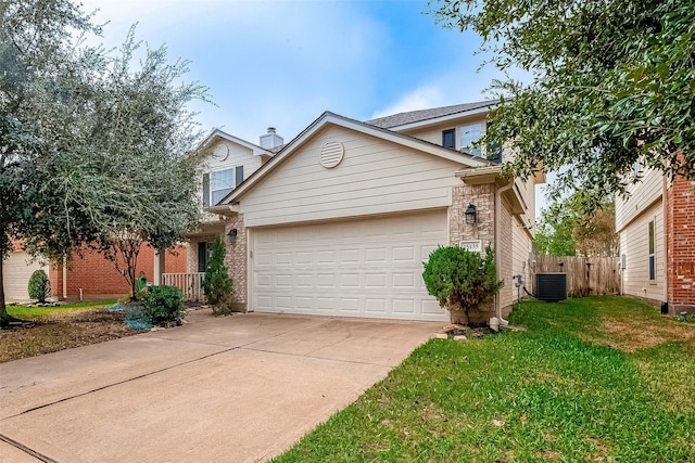 view of front of property featuring central AC unit, a garage, and a front lawn