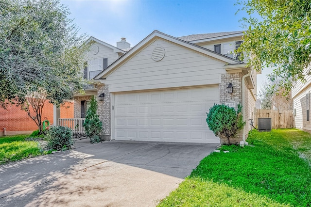 view of front of home with a front yard, a garage, and central air condition unit