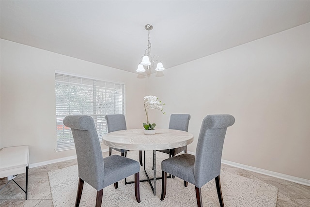 dining space with an inviting chandelier